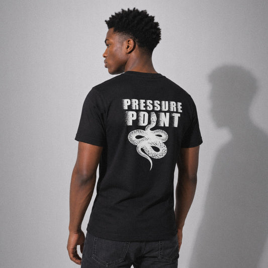 Back view of a grappler wearing the black Founder's Tee with the Pressure Point snake logo across the back